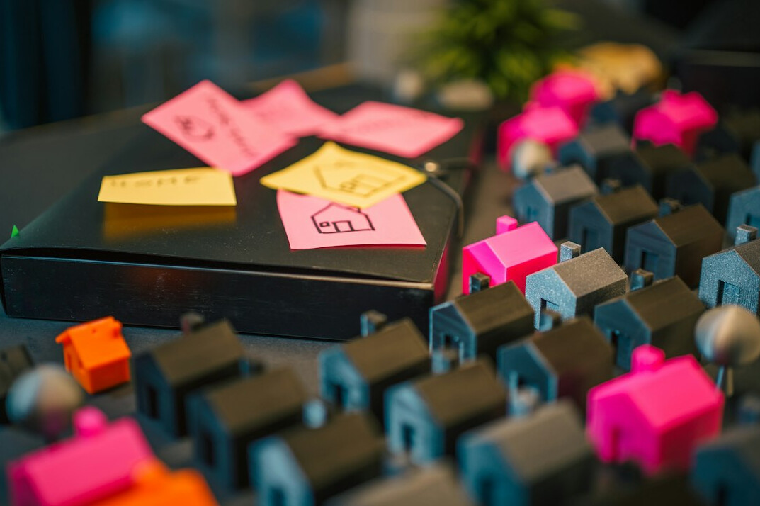 Desk covered with colorful sticky notes and a notebook during a brainstorming session